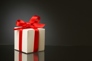 Little white box with red ribbon to celebrate a special Christmas